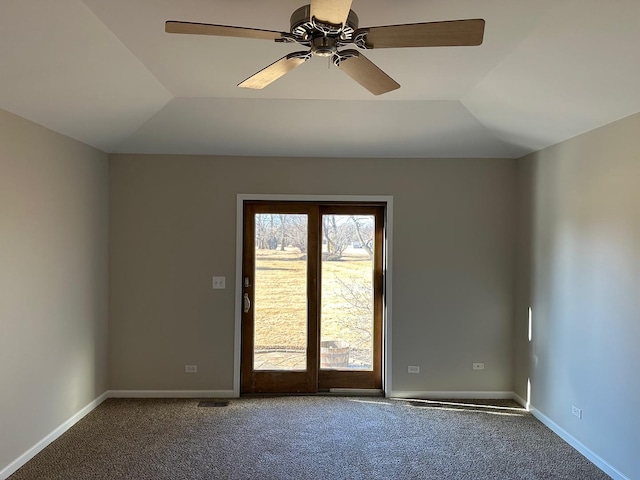 carpeted empty room with lofted ceiling, a ceiling fan, and baseboards