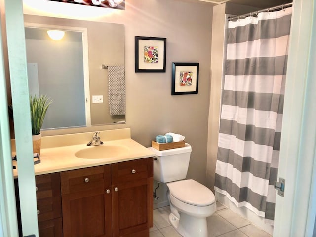 full bath featuring toilet, vanity, and tile patterned floors