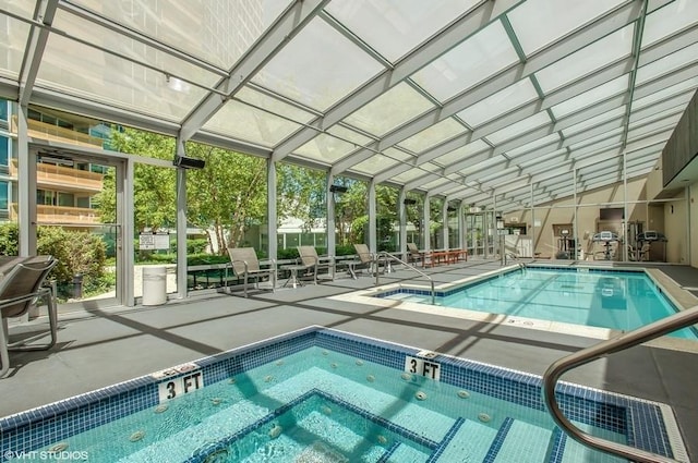 community pool with an indoor in ground hot tub and a patio