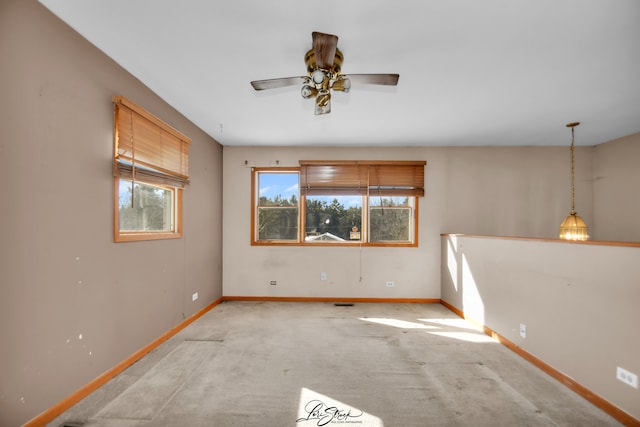 unfurnished room with carpet, baseboards, and ceiling fan