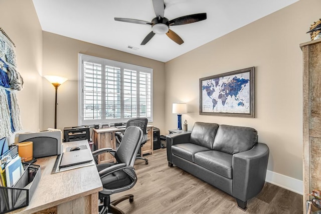 home office with visible vents, ceiling fan, baseboards, and wood finished floors