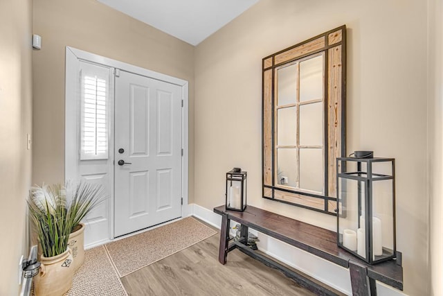 entrance foyer featuring baseboards and wood finished floors