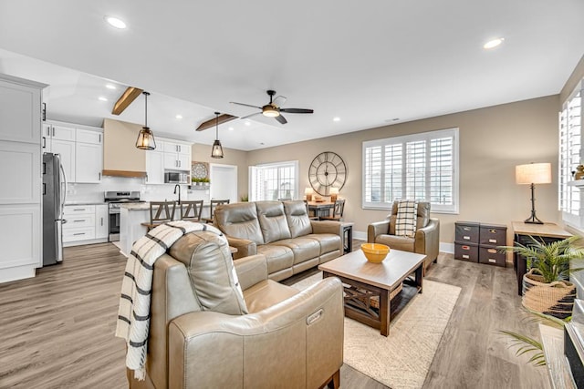 living room featuring light wood finished floors, baseboards, a ceiling fan, and recessed lighting