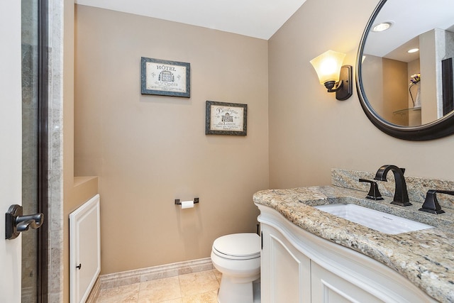 bathroom featuring toilet, tile patterned flooring, baseboards, and vanity