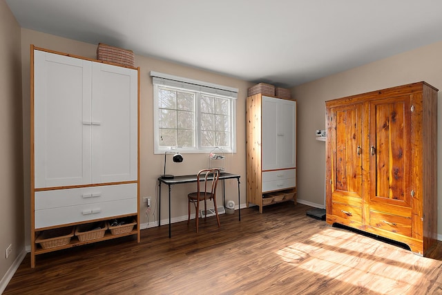 bedroom with wood finished floors and baseboards