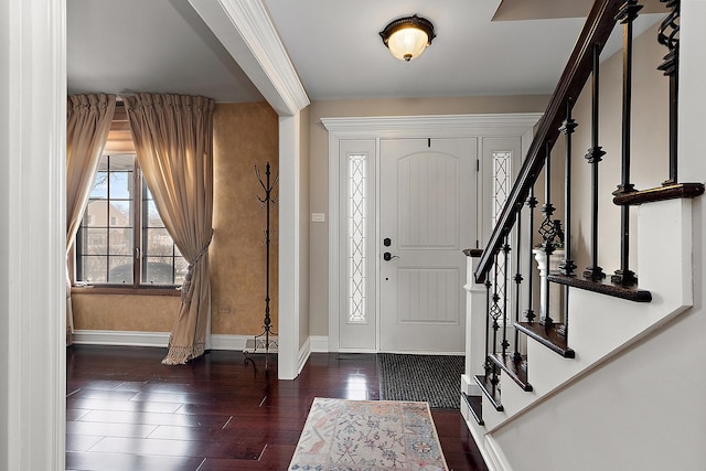 entrance foyer with stairway, baseboards, and wood finished floors