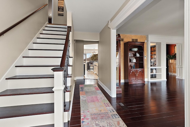 entrance foyer featuring stairs, baseboards, and wood finished floors