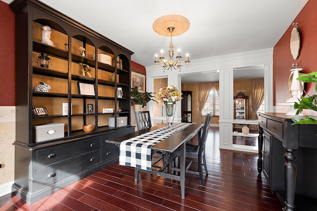 dining area featuring dark wood-style floors and a chandelier