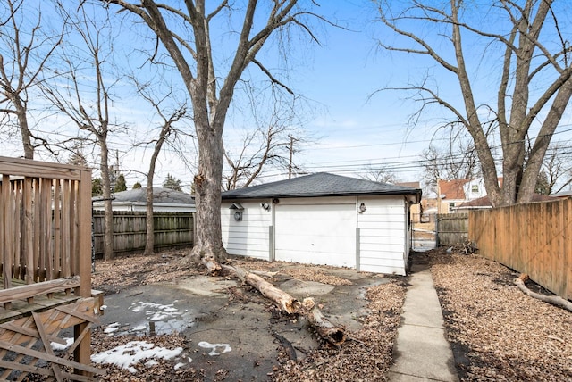 detached garage with fence and driveway