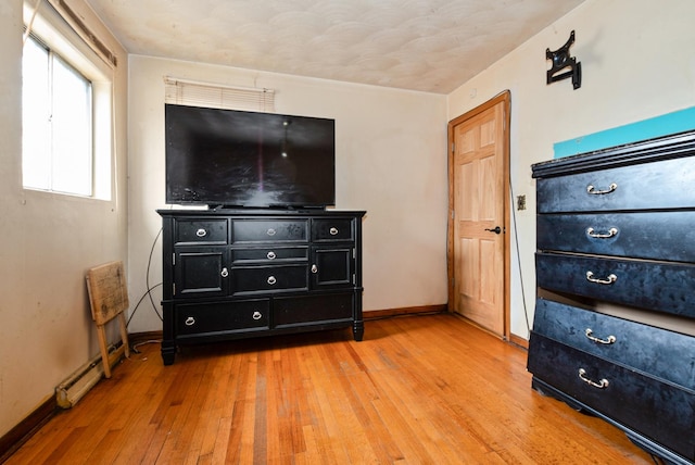 bedroom featuring light wood-style flooring and baseboards