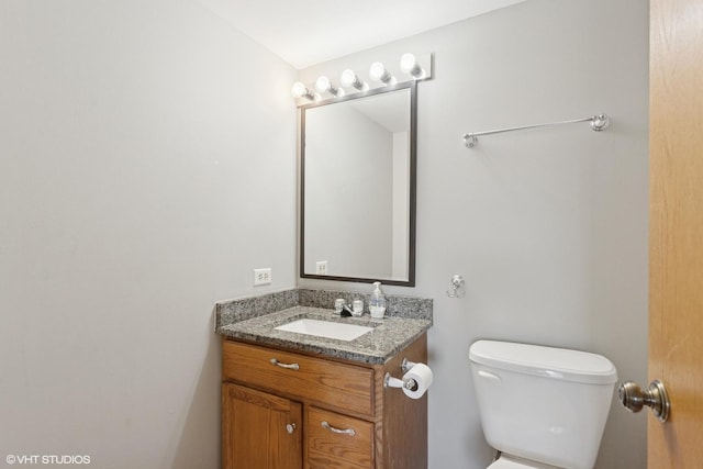 bathroom with toilet and vanity