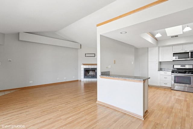 kitchen featuring visible vents, appliances with stainless steel finishes, white cabinetry, and light wood-type flooring