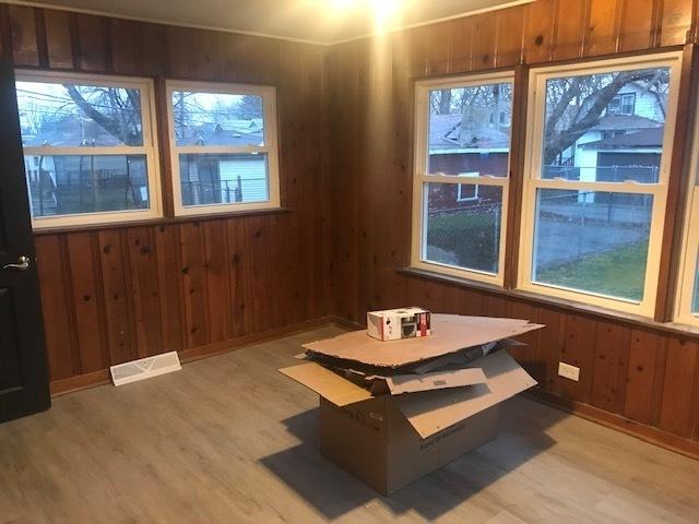 unfurnished dining area with a wealth of natural light, light wood finished floors, and visible vents