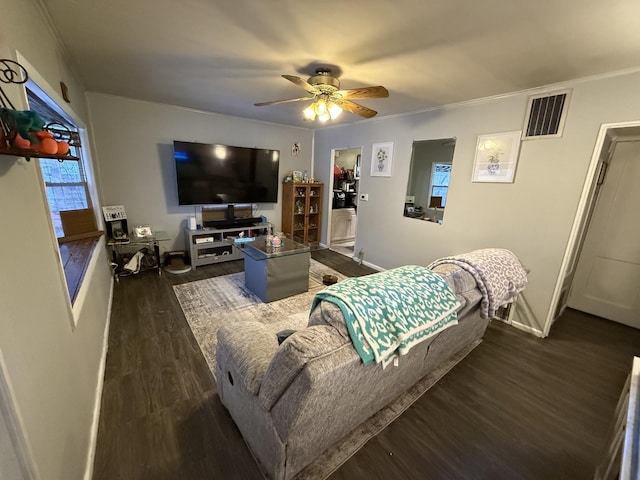 living room featuring crown molding, visible vents, dark wood finished floors, and ceiling fan