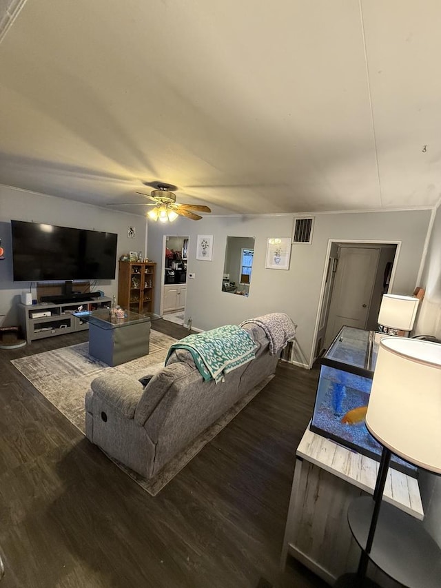 living area with ceiling fan, wood finished floors, and visible vents