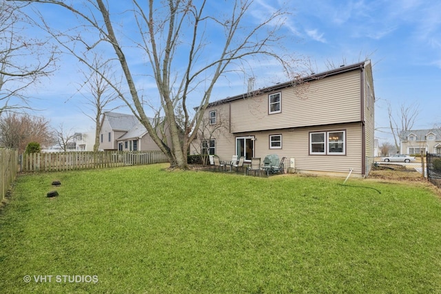 back of property featuring a patio area, a fenced backyard, and a yard