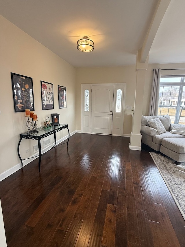 entrance foyer with baseboards, decorative columns, and hardwood / wood-style floors