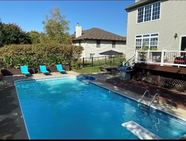 view of swimming pool featuring fence, a diving board, grilling area, a wooden deck, and a fenced in pool