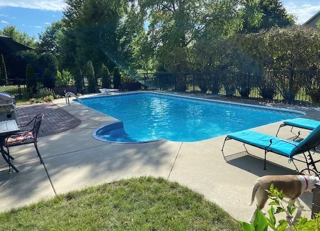 view of pool with a fenced in pool, fence, and a patio