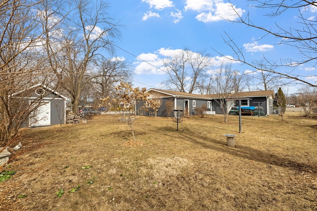 view of yard with a shed and an outbuilding