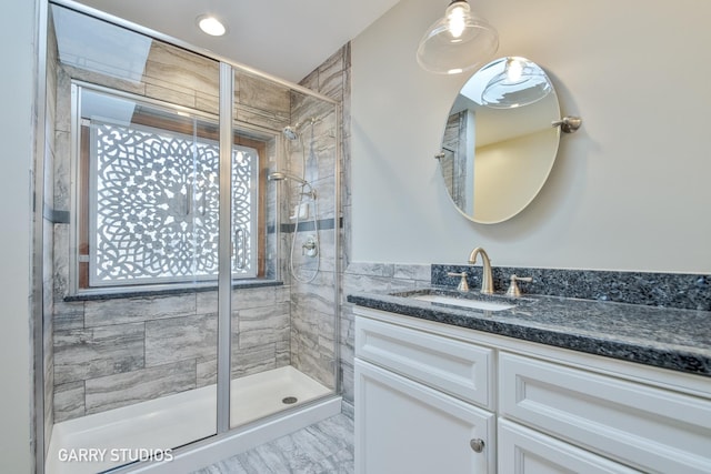 full bathroom featuring a shower stall and vanity