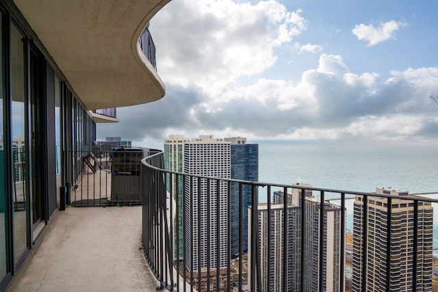 balcony featuring a view of city and a water view