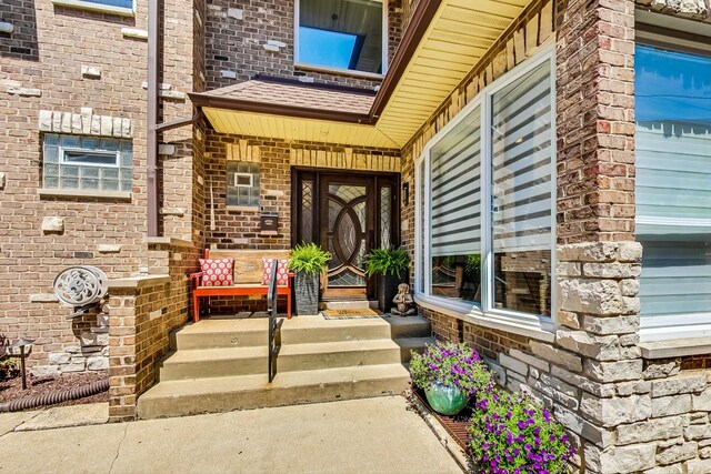 view of front of house with a garage, brick siding, and a chimney