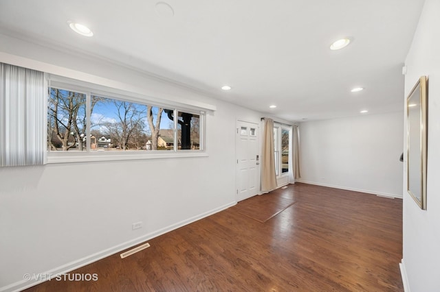 entryway featuring baseboards, visible vents, wood finished floors, and recessed lighting