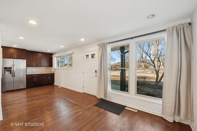 doorway with baseboards, dark wood-style flooring, visible vents, and recessed lighting