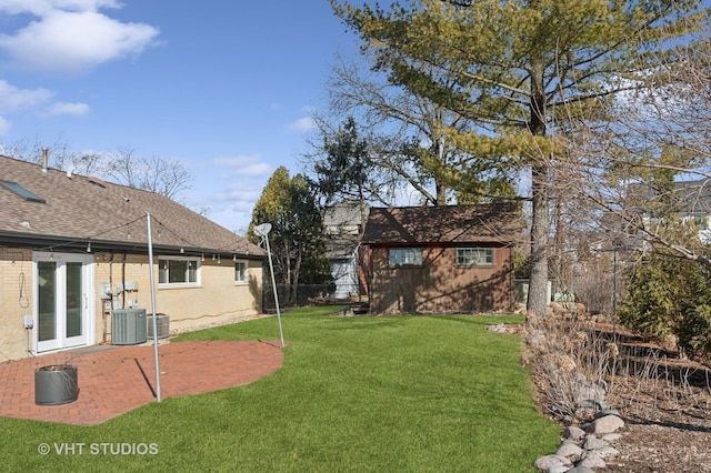 view of yard with central air condition unit, a patio area, and fence