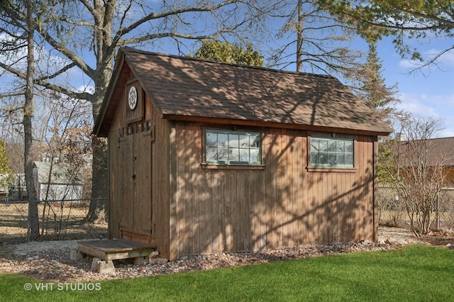 view of shed featuring fence