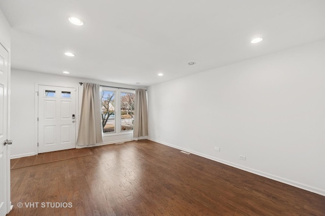 spare room featuring recessed lighting, visible vents, baseboards, and wood finished floors