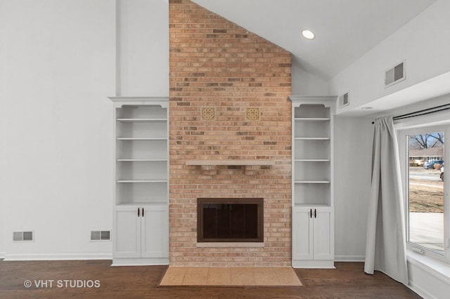 unfurnished living room featuring visible vents, dark wood finished floors, and vaulted ceiling