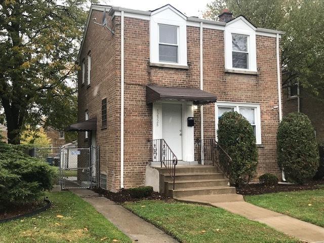 multi unit property with a gate and brick siding