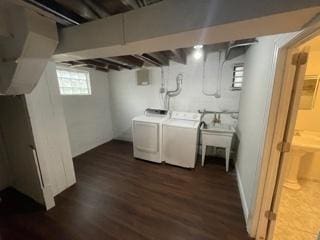 washroom featuring laundry area, dark wood-style flooring, and washer and dryer