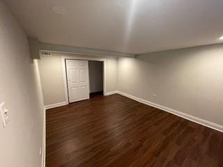 finished basement with dark wood-style floors and baseboards