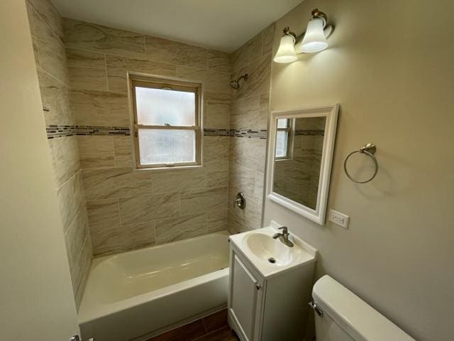 bathroom with shower / bathing tub combination, vanity, toilet, and wood finished floors