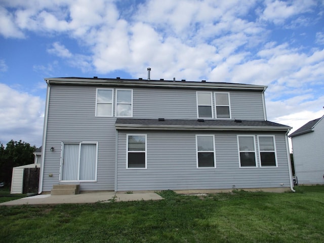 back of property featuring entry steps, a patio area, and a yard