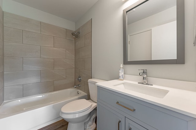 bathroom with toilet, bathing tub / shower combination, vanity, and wood finished floors