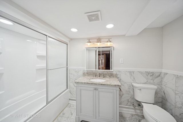 bathroom with toilet, marble finish floor, visible vents, and vanity