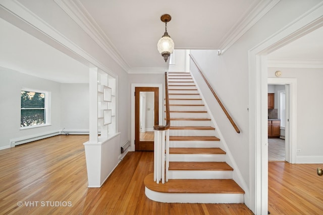 stairway featuring crown molding, baseboards, baseboard heating, and wood finished floors