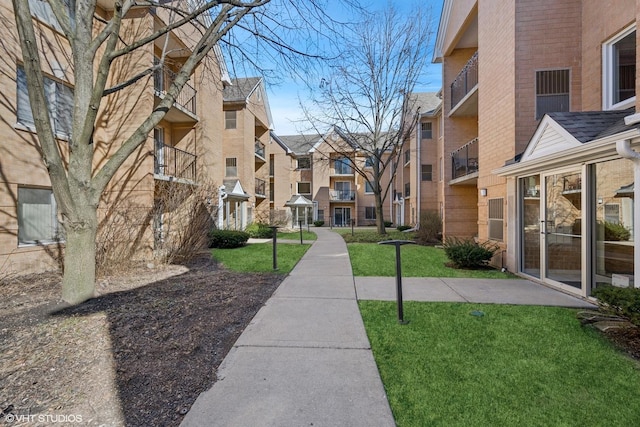 view of property's community with a lawn