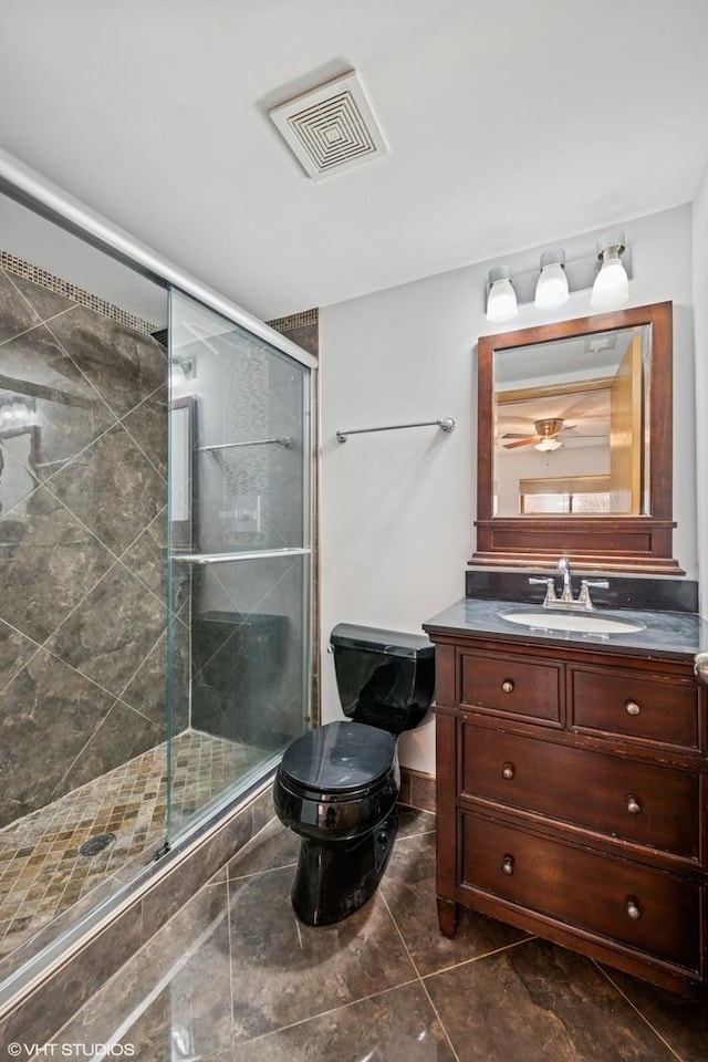 full bath featuring visible vents, toilet, vanity, and a shower stall