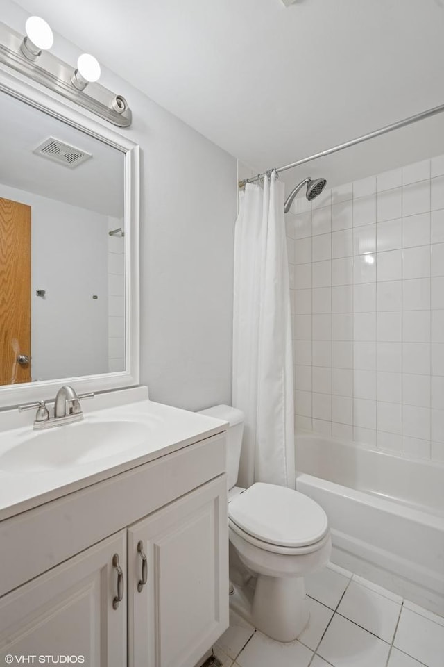 full bathroom with visible vents, toilet, shower / bath combo with shower curtain, vanity, and tile patterned flooring