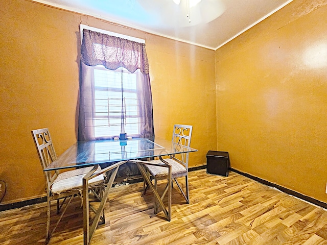 dining space with wood finished floors and baseboards