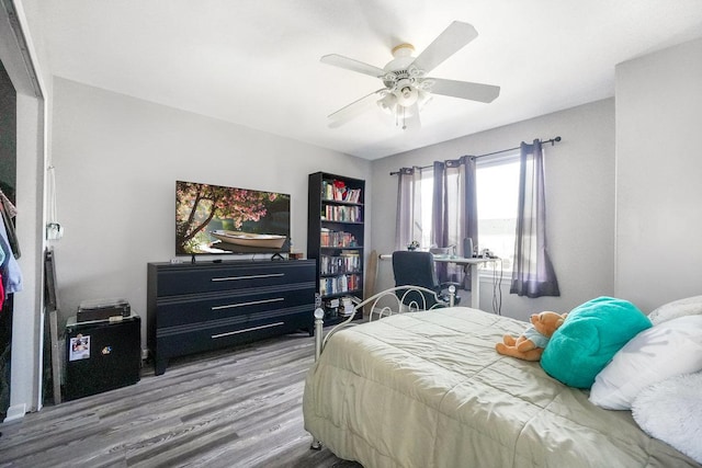 bedroom featuring a ceiling fan and wood finished floors