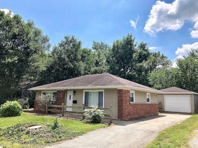 ranch-style home featuring driveway, brick siding, an outdoor structure, and a detached garage