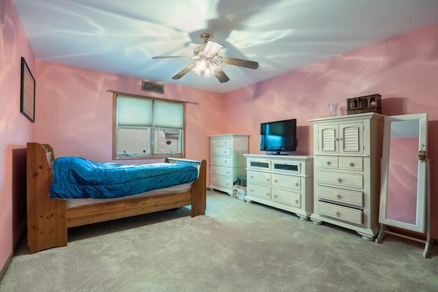 bedroom featuring light carpet, ceiling fan, and visible vents