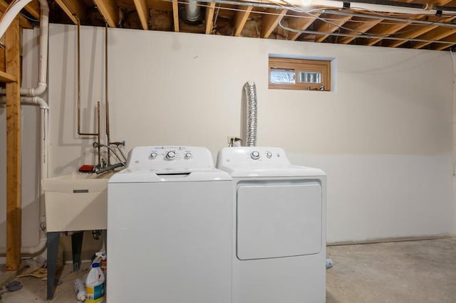 laundry area with a sink, laundry area, and washing machine and dryer