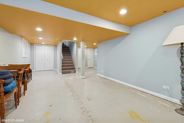 finished below grade area with stairway, recessed lighting, and baseboards